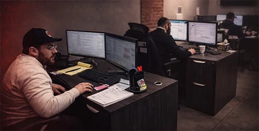 Central station operator monitoring fire alarm signals