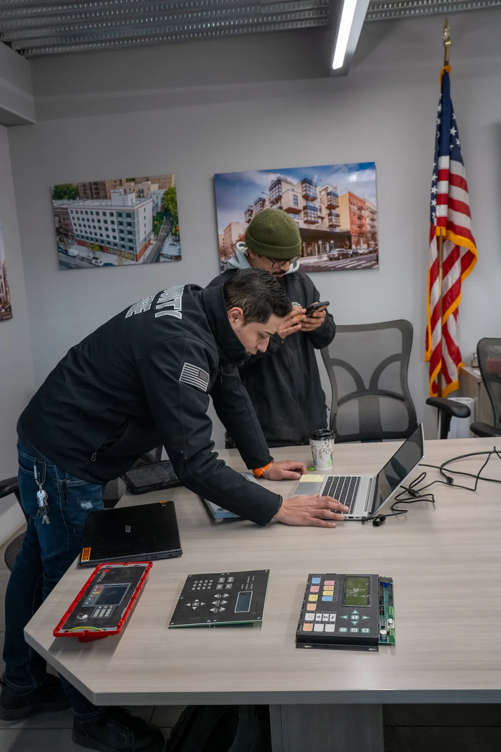 County Fire technicians diagnosing fire alarm control panels at the shop