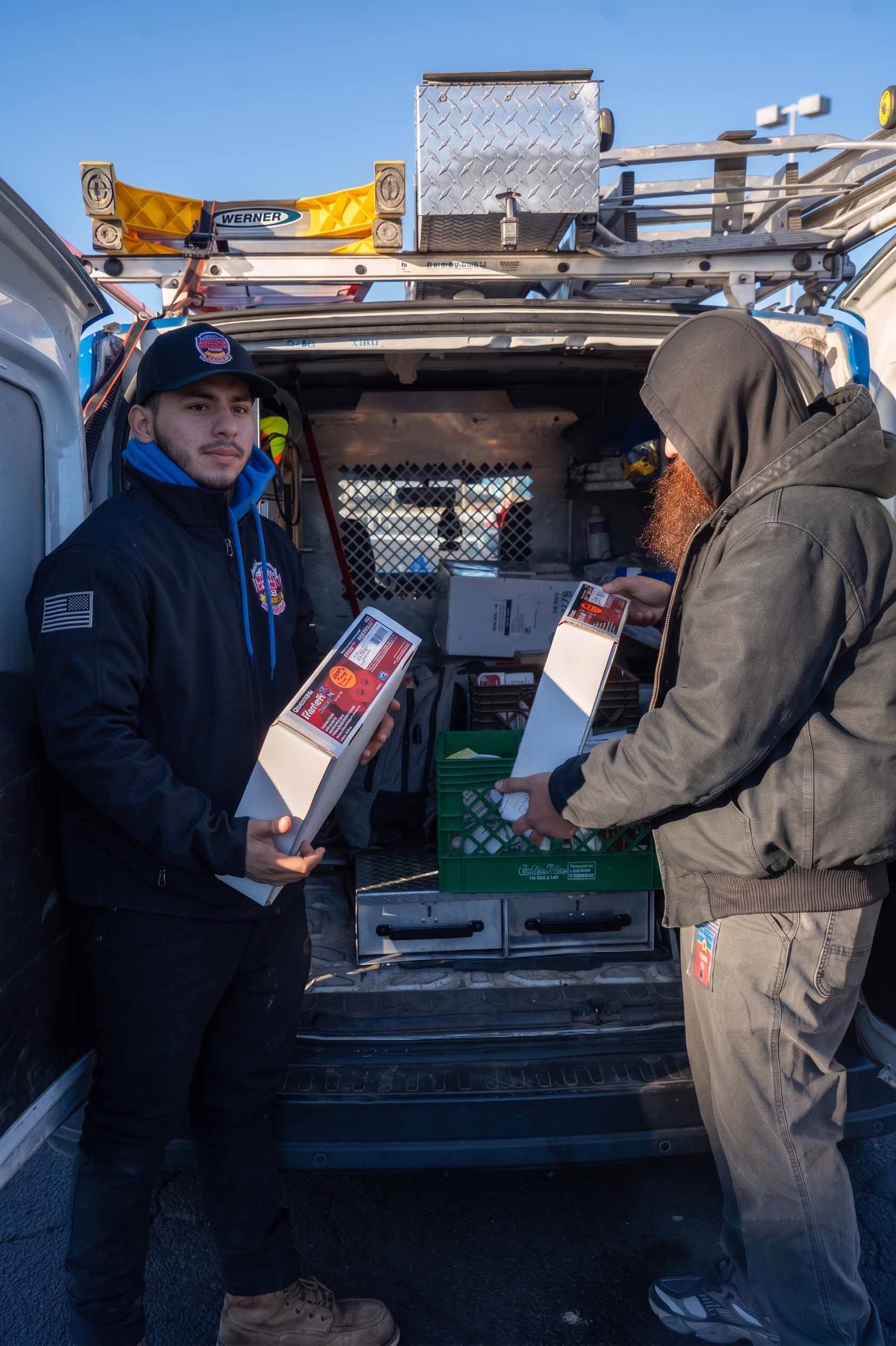 County Fire technicians handing off equipment for a fire alarm communicator installation