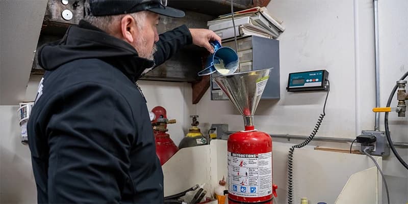 County Fire technician recharging a fire extinguisher in NYC