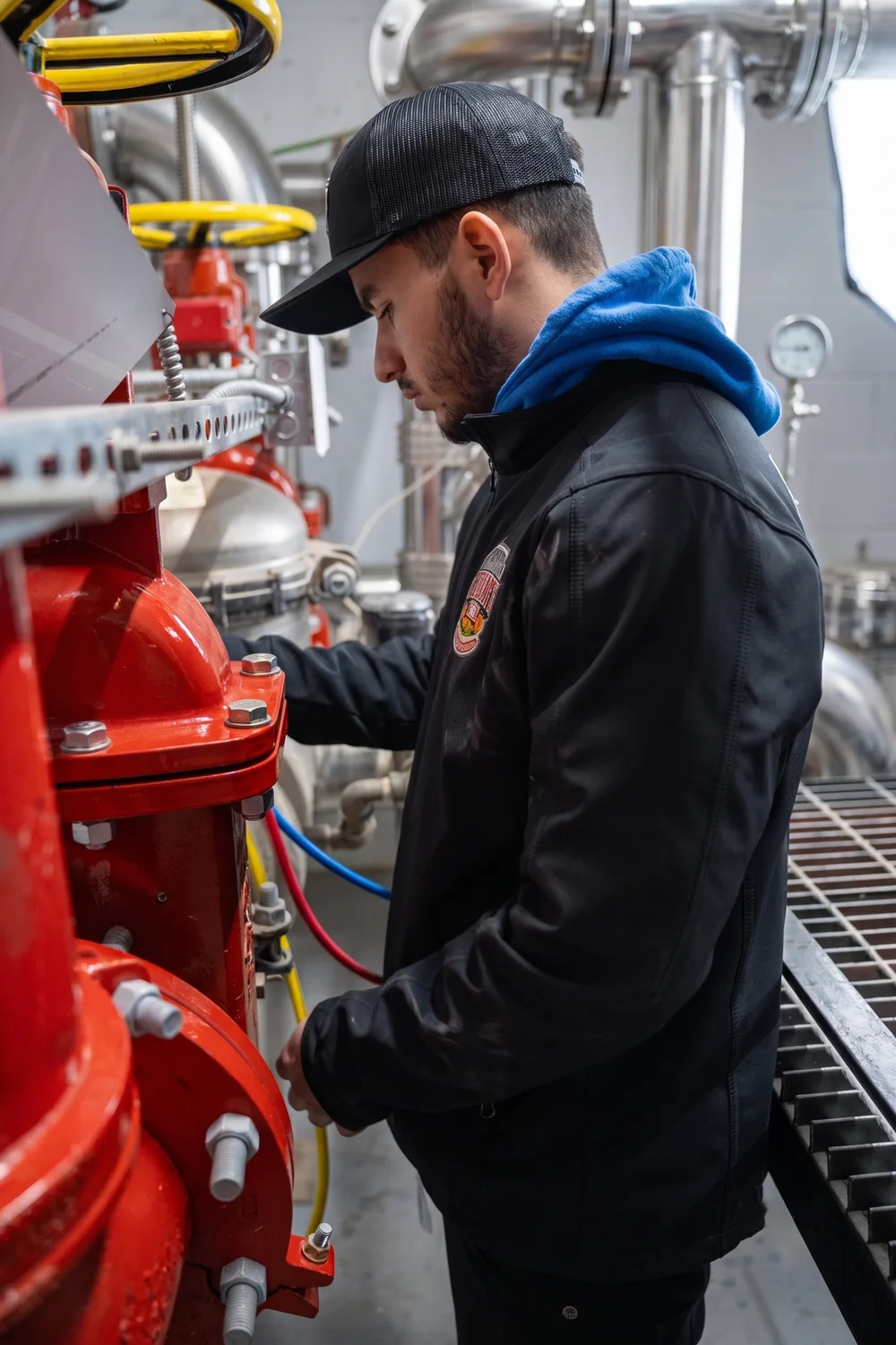 County Fire technician servicing a fire sprinkler alarm valve assembly