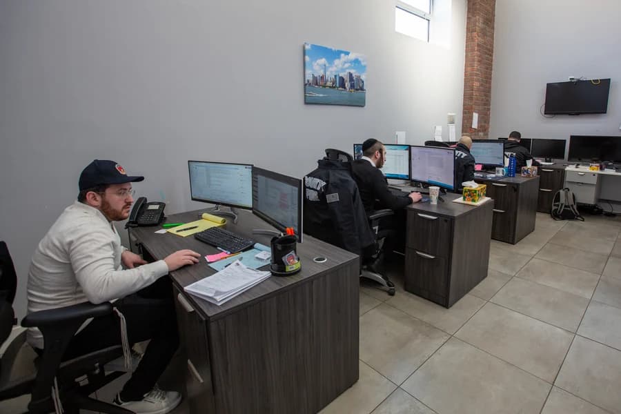 County Fire office staff working at desks in the Brooklyn office