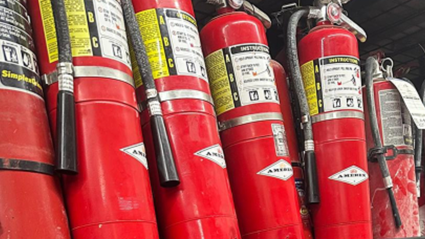 technician inspecting fire extinguisher – NFPA 10 annual inspection